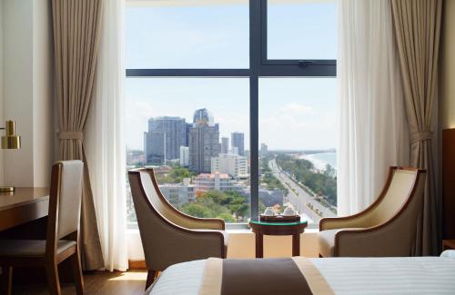 a hotel room with a view of a city at Victory Hotel Vung Tau in Vung Tau