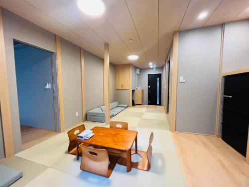 a room with a table and chairs and a bed at 新宿6 Home in Tokyo