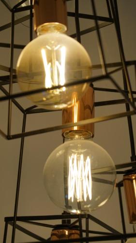 two lights are hanging from a ceiling at Stay on Summer - CBD Apartment in Orange