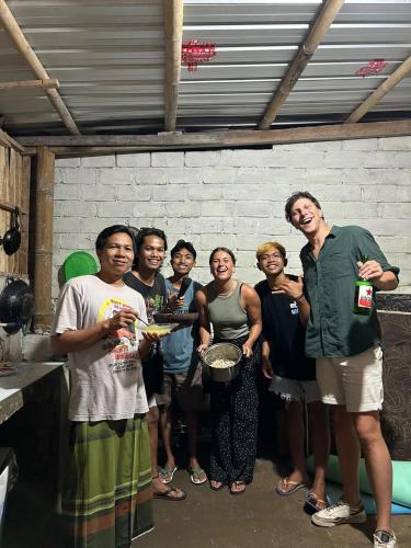 a group of people posing for a picture in a kitchen at Tetebatu Fullmoon in Tetebatu