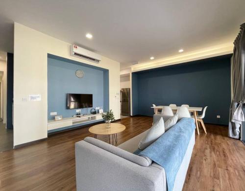 a living room with a couch and a table at Roxy Sematan Beach Townhouse Deluxe 3 ,5 & 6 in Sematan