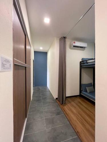 a hallway of a room with a room with a bed at Roxy Sematan Beach Townhouse Deluxe 3 ,5 & 6 in Sematan