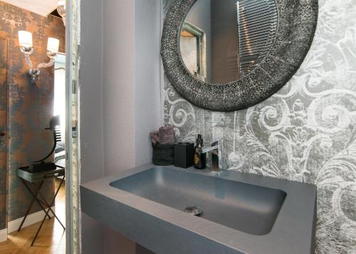 a bathroom with a sink and a mirror at Rialto Terrace on the Grand Canal in Venice