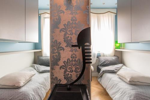 a surfboard standing in a room with two beds at Rialto Terrace on the Grand Canal in Venice