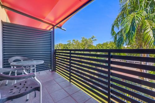 a balcony with a table and a fence at Vitina Studio Motel in Darwin