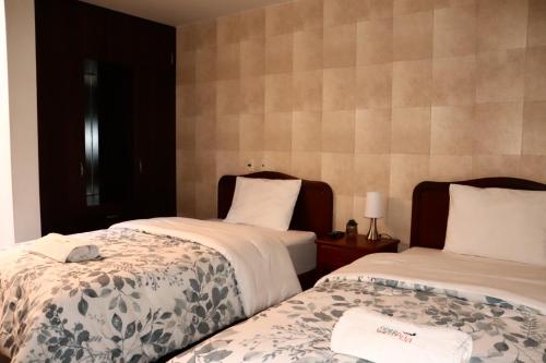 two beds in a room with two beds sidx sidx sidx at Sierra Alta Colca in Chivay