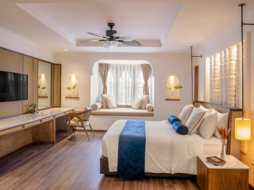 a bedroom with a large bed and a couch at Sarai and Wander Resort in Siem Reap