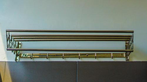a row of metal pipes on a wall at Dirga's House Sanur View by EPS in Sanur