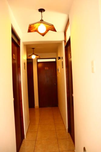 a hallway with a ceiling fan and a hallway with a door at Sierra Alta Colca in Chivay