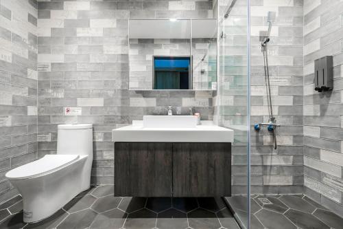a bathroom with a sink and a toilet and a shower at MH48 Hotel in Kenting