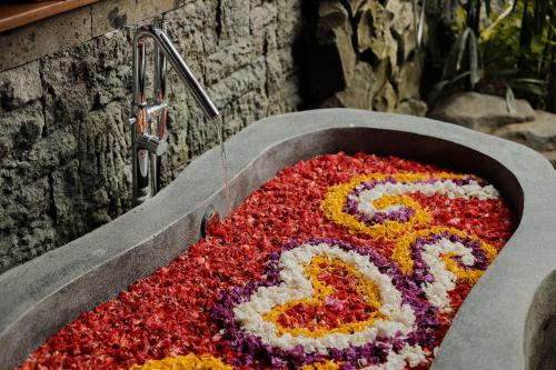 a flower arrangement in a sink with the number six at Agastya Ubud Villa in Ubud