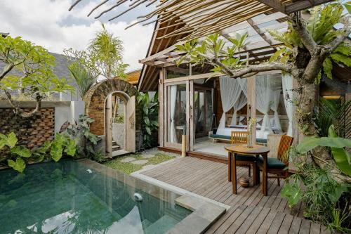 a house with a swimming pool and a patio at Agastya Ubud Villa in Ubud