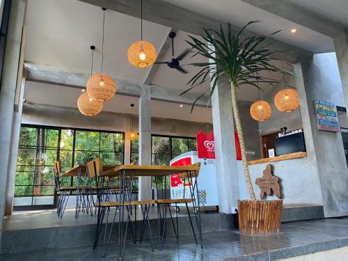 a restaurant with a table and chairs and lights at Mayong Bali Villa and Hostel in Munduk