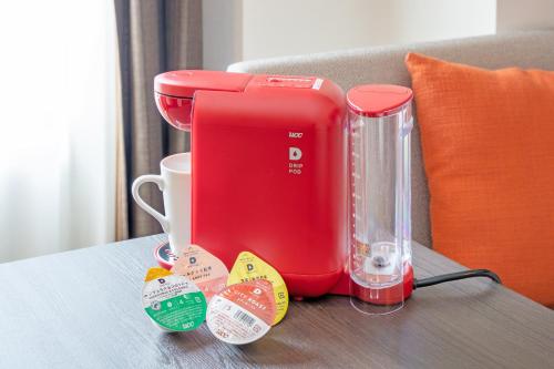a red blender sitting on top of a table at Hotel JAL City Nagano in Nagano