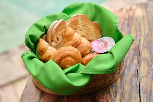 a basket filled with pastries on a wooden table at Agastya Ubud Villa in Ubud