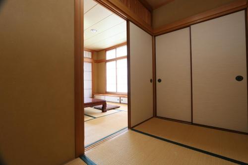 an empty room with a door and a window at 城下町に佇む癒しの宿 旅館 大政 in Karatsu