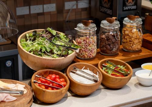 a bunch of bowls of food on a table at Sotetsu Grand Fresa Bangkok in Bangkok