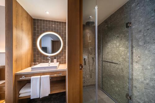 a bathroom with a sink and a shower at Sotetsu Grand Fresa Bangkok in Bangkok