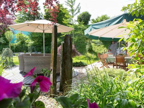 a patio with an umbrella and a table and chairs at Gasthof Schopper in Breitenbach am Inn