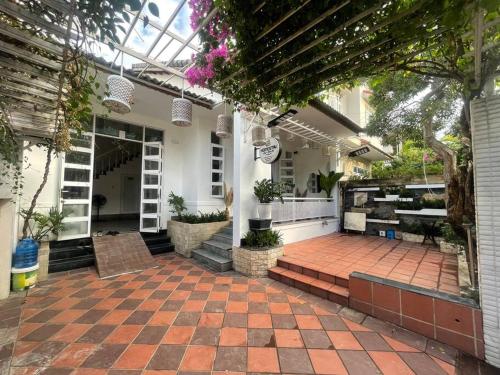a conservatory with a brick patio with potted plants at Citadel Villa- Kinh Đô Huế in Hương Trà