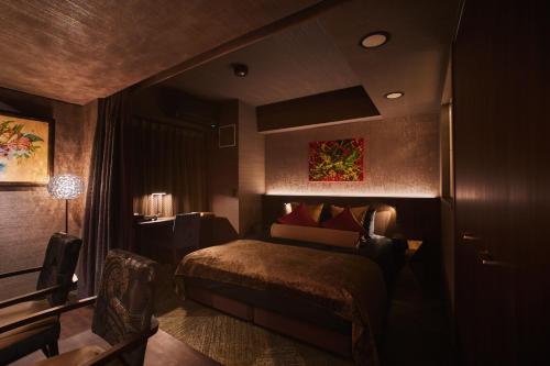a hotel room with a bed and a desk at Roppongi Hotel S in Tokyo