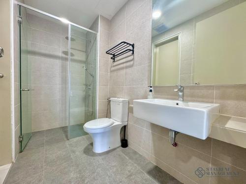 a bathroom with a toilet and a sink and a shower at Bali Sea View Residences Melaka at Stayrene in Melaka