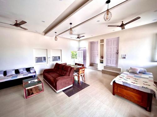 sala de estar amplia con sofá y mesa en Gooseberry Garden en Ayodhya