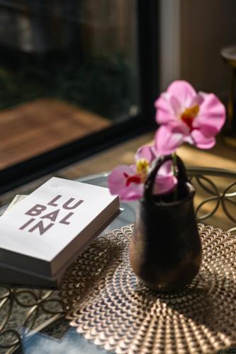 a book and a flower in a purse on a table at StayAU Stylish Spacious 4BR Home Ringwood in Ringwood East