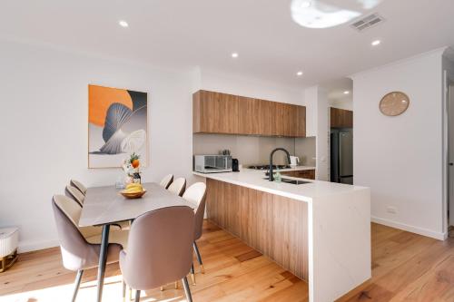 a kitchen and dining room with a table and chairs at StayAU Stylish Spacious 4BR Home Ringwood in Ringwood East