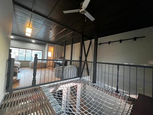 a balcony of a house with a ceiling fan at 貸し切りゲストハウスsai2nd in Yasugi