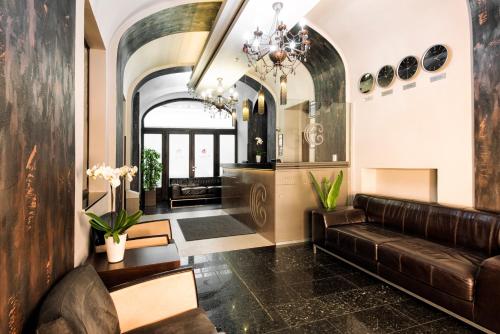 a living room with a couch and a chandelier at Carat Boutique Hotel in Budapest