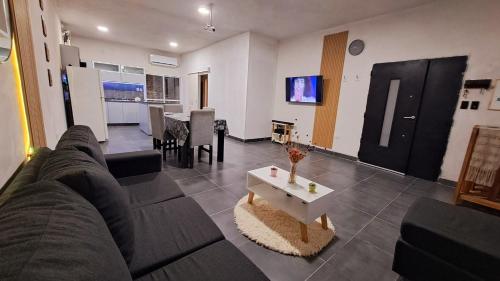 ein Wohnzimmer mit einem Sofa und einem Tisch in der Unterkunft Casa Valle Viejo in San Fernando del Valle de Catamarca