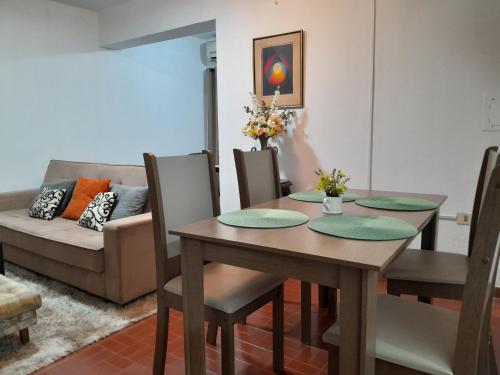 a dining room with a table and a couch at OBhouse Apartment, para sentirse como en casa! in Asuncion