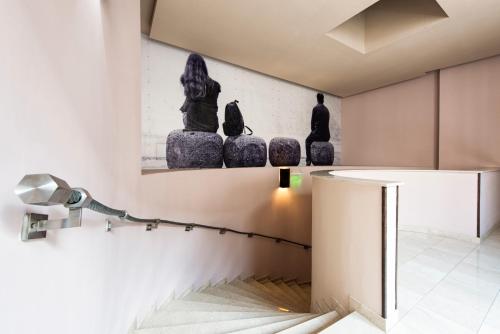 a room with a table and two statues on the wall at Carat Boutique Hotel in Budapest