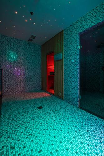 an empty room with green tiles on the wall at Carat Boutique Hotel in Budapest