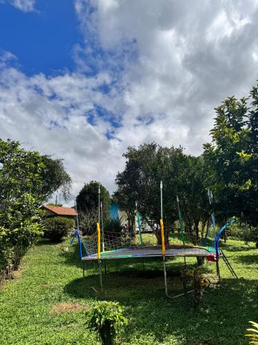 a park with a playground with a swing set at Pousada Dona Chica in Visconde De Maua