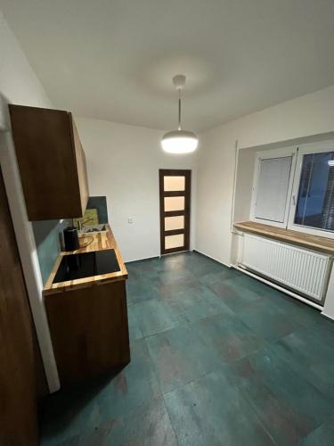 an empty room with a kitchen with a sink at Mikulovská chalupa in Mikulov