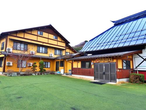 a house with a large yard in front of it at Hanasaku Onsen Yoshiyaso in Katashina