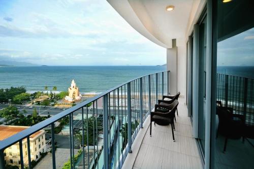 a balcony with a view of the ocean at Panorama Nha Trang Condotel by One in Nha Trang