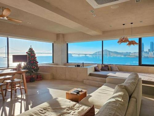 a living room with a christmas tree in it with a view at Paradise on earth in Busan