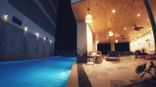 a large swimming pool in a building at night at Panorama Nha Trang Condotel by One in Nha Trang