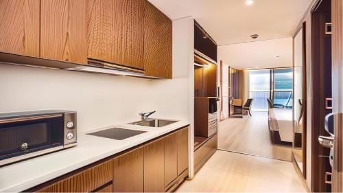 a kitchen with a sink and a microwave at Panorama Nha Trang Condotel by One in Nha Trang