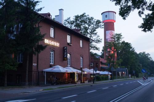 a building on the side of a street with a lighthouse at Savoy in Spała
