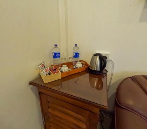 a table with two bottles of water on top of it at SurfBayVilla in Dickwella