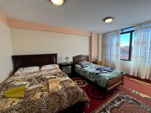 Katil atau katil-katil dalam bilik di Departamento amplio familiar y cómodo en El Alto