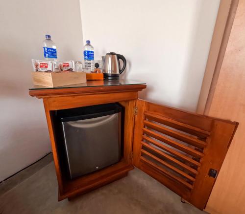 a small television with a coffee pot on top of it at SurfBayVilla in Dickwella