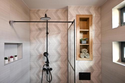 a shower with a glass door in a bathroom at Apartmani Vito in Biograd na Moru
