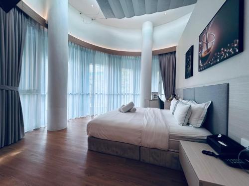 a bedroom with a large bed and a large window at AP Concept Hotel in Petaling Jaya