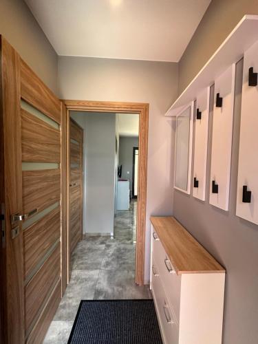 a hallway with a closet and a door at Nova 26 in Klucze