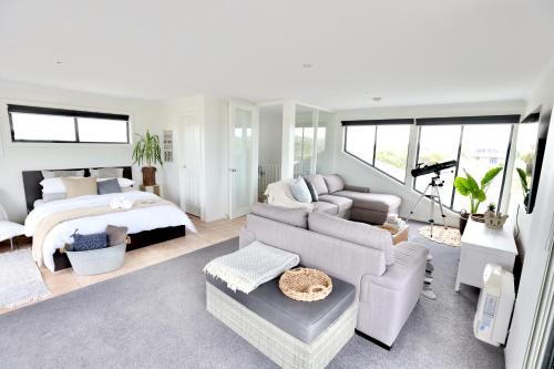 a living room with a bed and a couch and a bedroom at Harbour Haven*Sea View*WIFI*Wine*Walk to the Beach in Robe